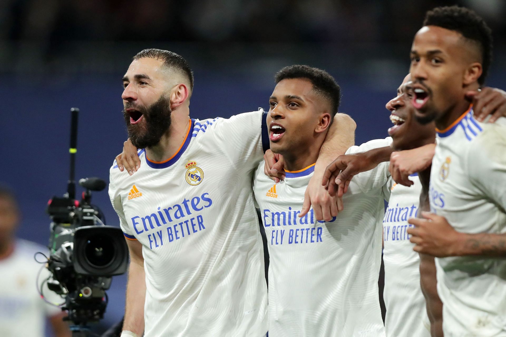 Real Madrid players celebrate after scoring a goal.